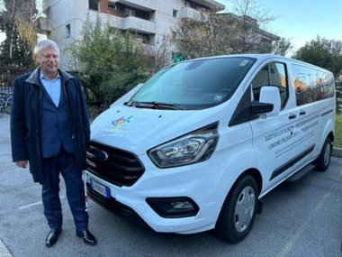 Foto: Der Vorsitzende Dr. Valter Calò vor dem Kleinbus des Verbandes